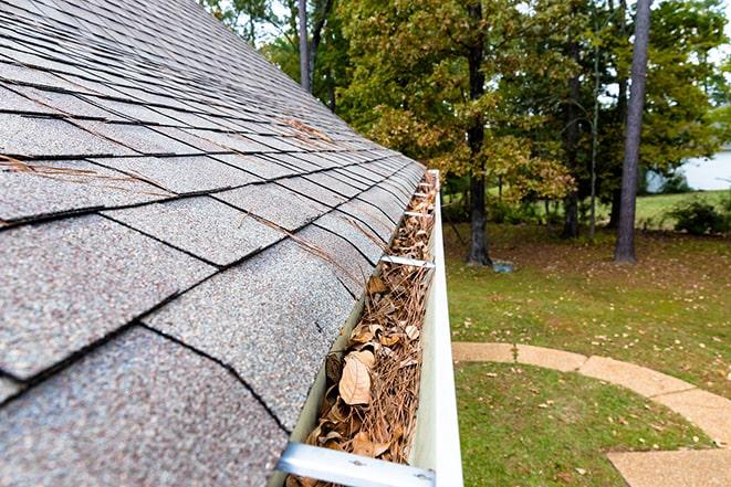 debris being removed from clogged gutters